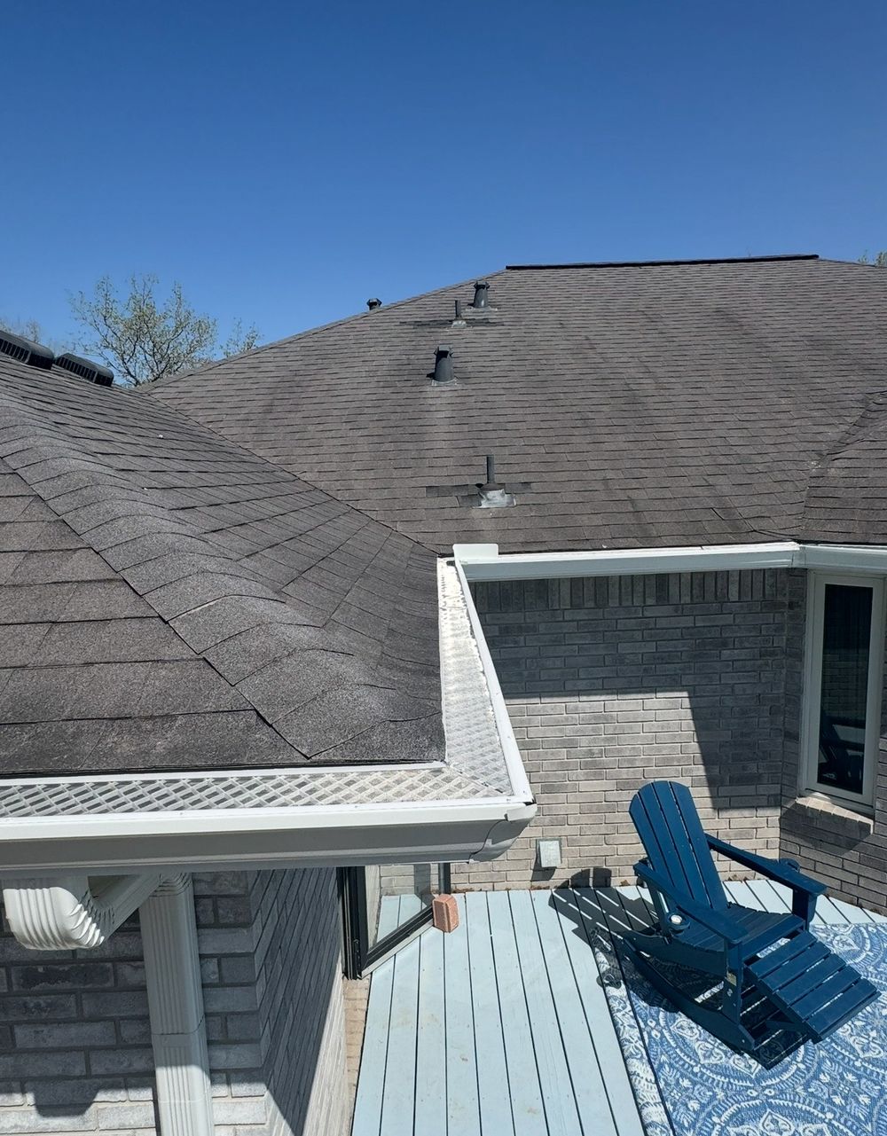 Clean gutter guard installation viewed from the deck of an Upstate home on a sunny day